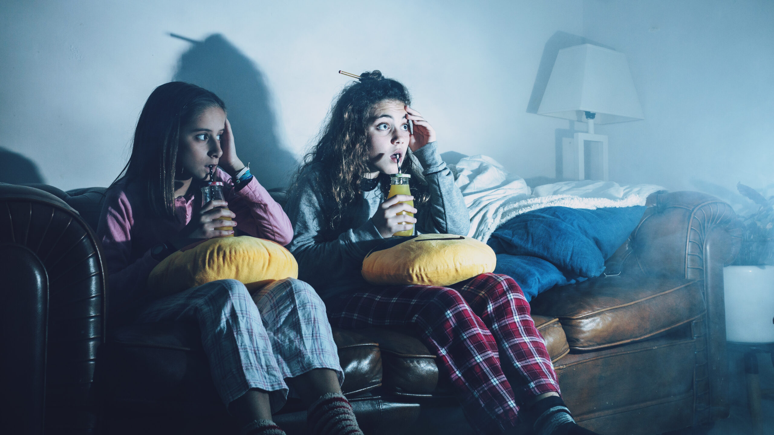 2 young girls scared watching a horror film 