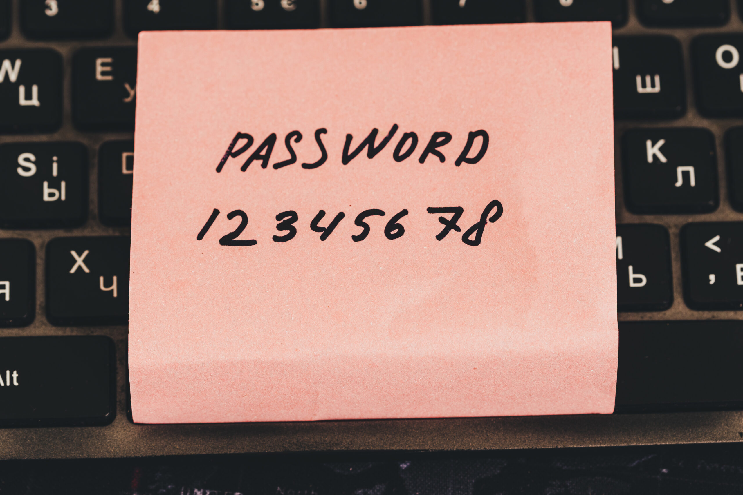 image of a post it note on a keyboard saying "password 12345678"